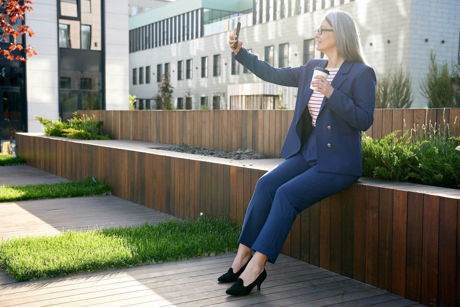 Successful estate agent taking a video of herself in fancy suit